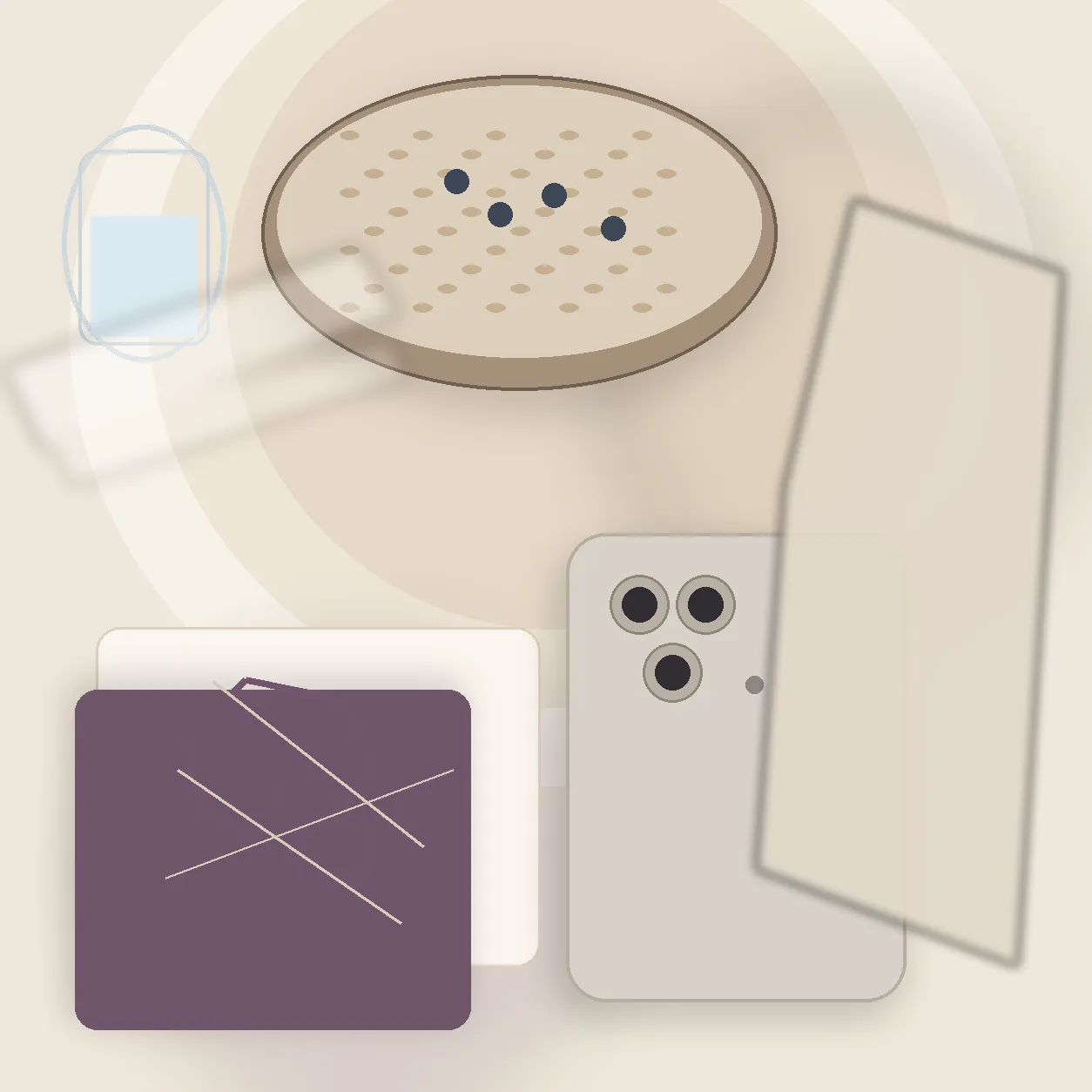 A phone face down on a table beside a glass of water and a notebook.